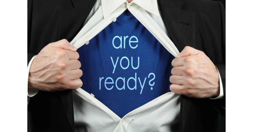 Businessman opening suit to reveal shirt with the words “Are you ready?”