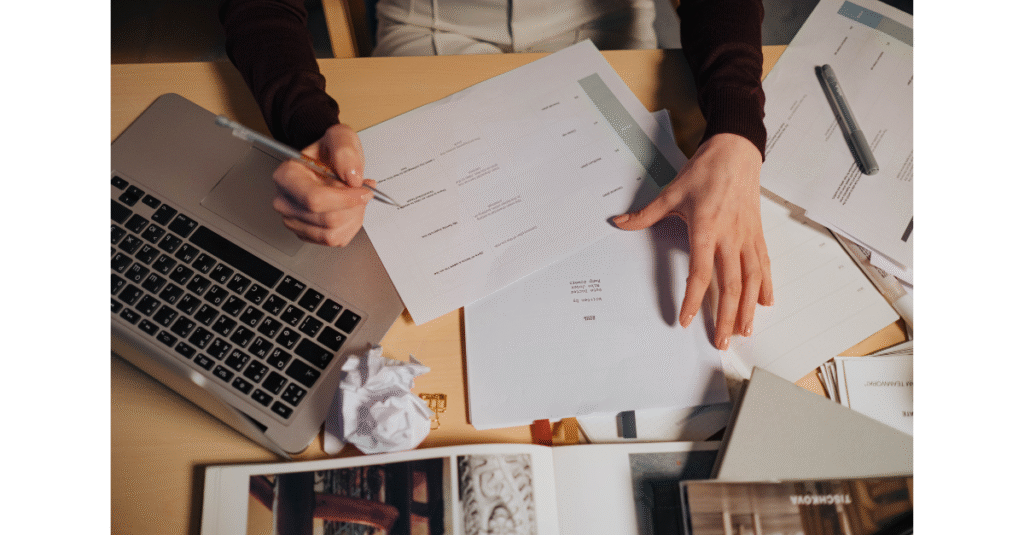 Papers spread across a conference table, representing the weight of decisions and responsibilities in law firm leadership.