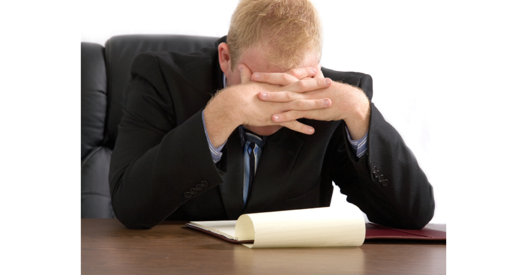 xA thoughtful law firm leader reviewing notes with a calm but focused expression, representing reflection on burnout, leadership, and peak performance without exhaustion.